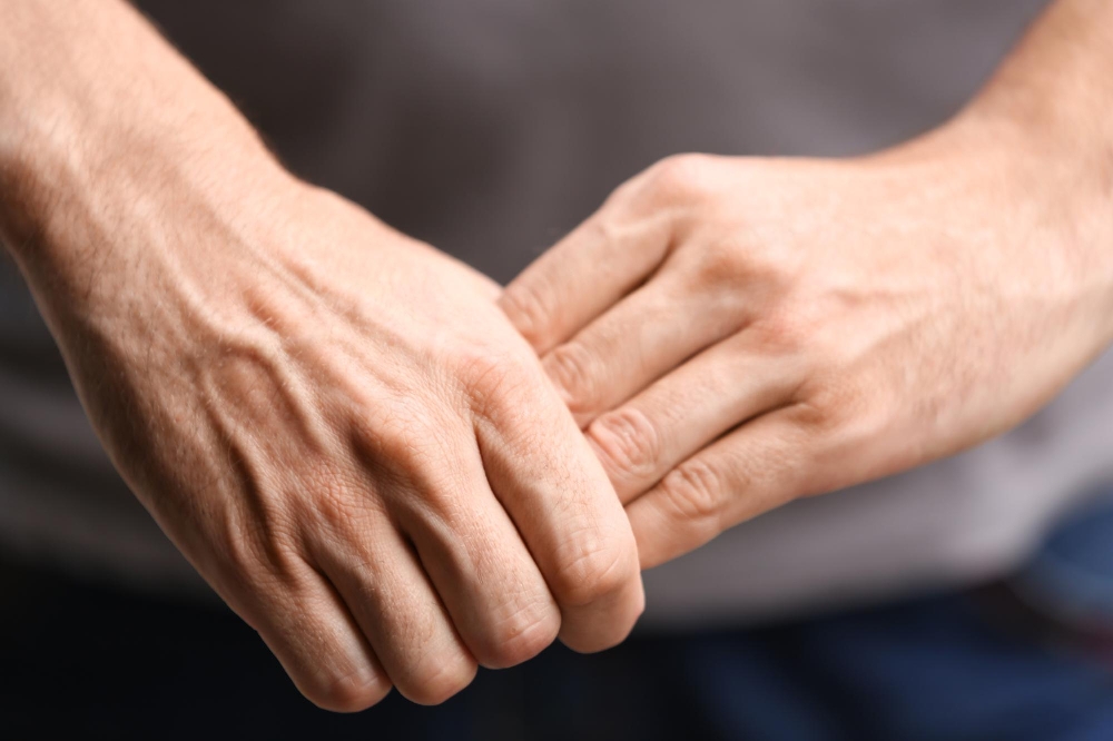 Fingers gently press into the palm and wrist area.